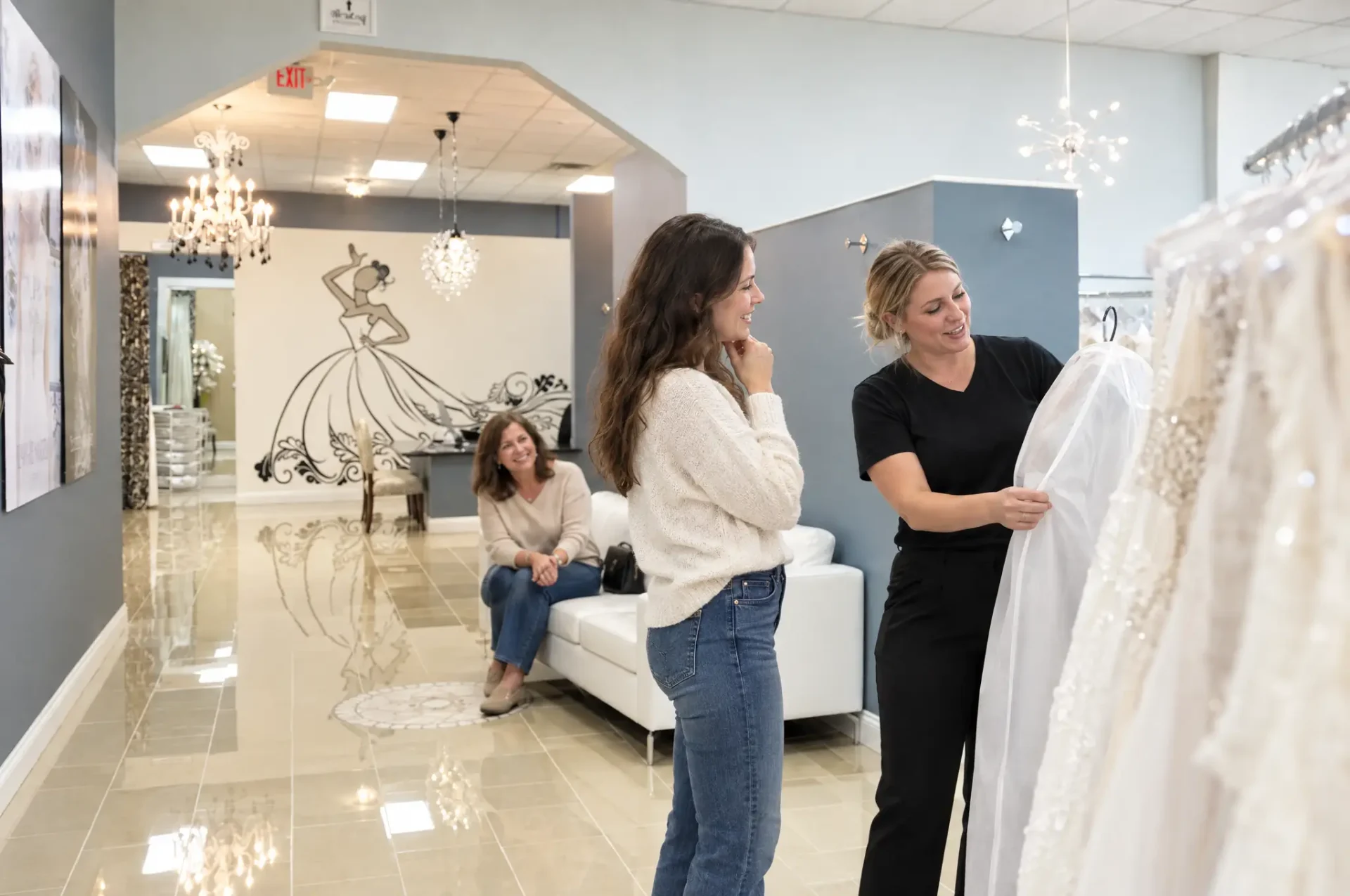 Bride-to-be and her mother browsing wedding gowns with a Bridal Stylist at New York Bride & Groom of Raleigh